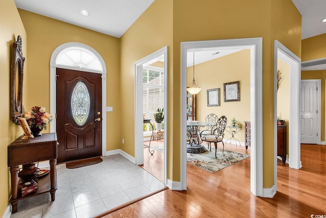 entryway with wood finished floors and baseboards