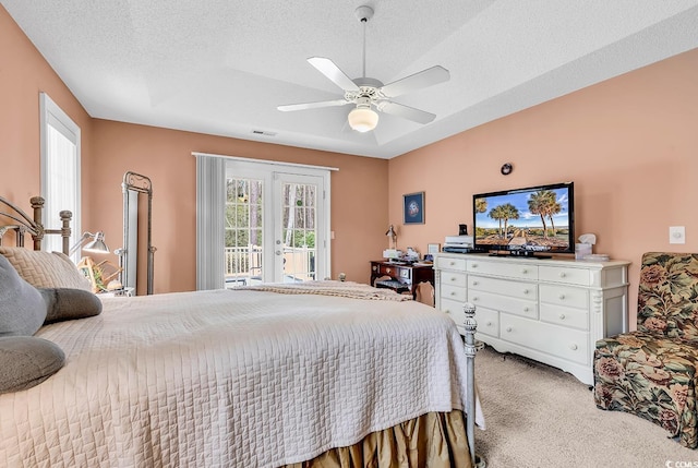 bedroom with access to exterior, visible vents, carpet flooring, french doors, and a textured ceiling