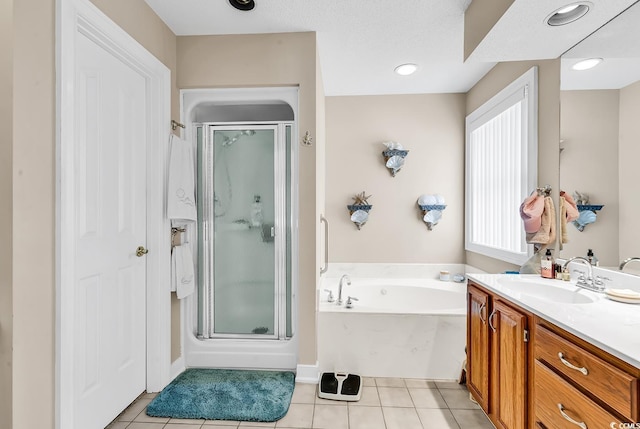 bathroom featuring a garden tub, a stall shower, and tile patterned flooring