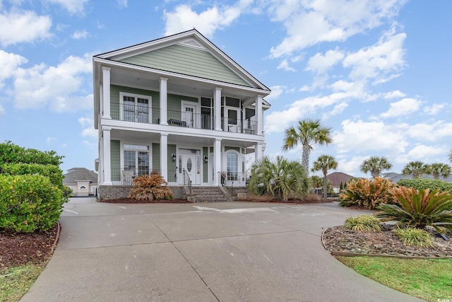 view of front of house with a balcony and covered porch
