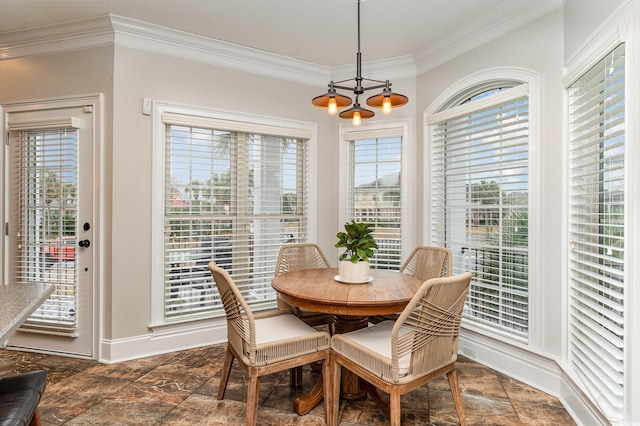 dining space with crown molding, a chandelier, baseboards, and dark stone finish flooring