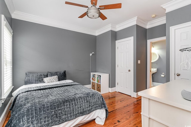 bedroom featuring baseboards, a ceiling fan, light wood-style floors, and ornamental molding