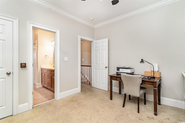 home office with ornamental molding, light colored carpet, a ceiling fan, and baseboards