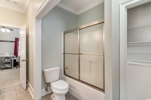 bathroom featuring toilet, ornamental molding, combined bath / shower with glass door, and tile patterned flooring