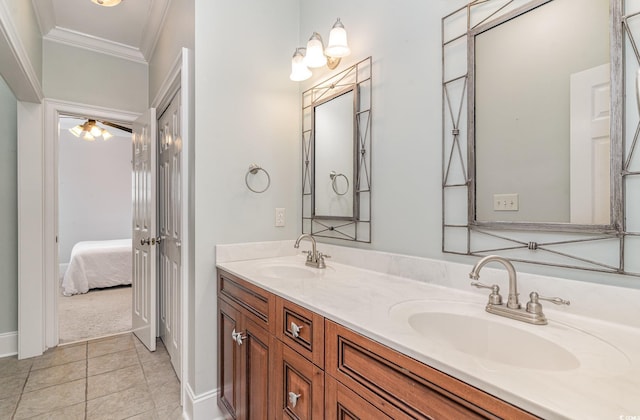 full bath featuring a sink, double vanity, crown molding, and tile patterned floors