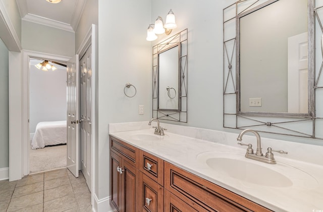 full bath with ornamental molding, double vanity, tile patterned flooring, baseboards, and ensuite bathroom