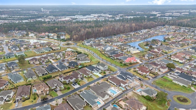aerial view of property's location with nearby suburban area and a nearby body of water