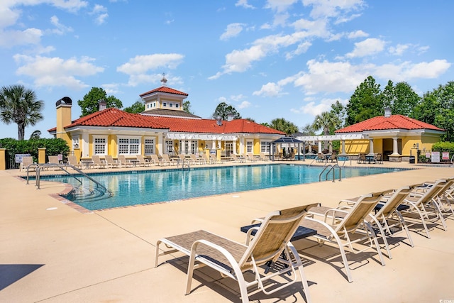 pool featuring a patio and fence