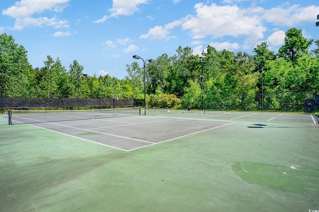 view of sport court featuring fence