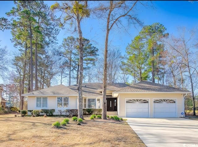 ranch-style house with a garage and concrete driveway