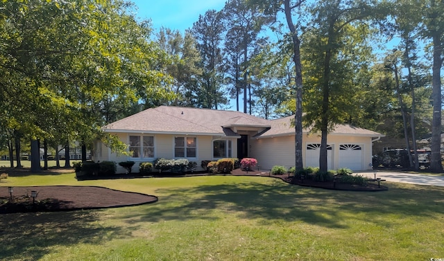 view of front facade featuring a garage, a front lawn, driveway, and roof with shingles