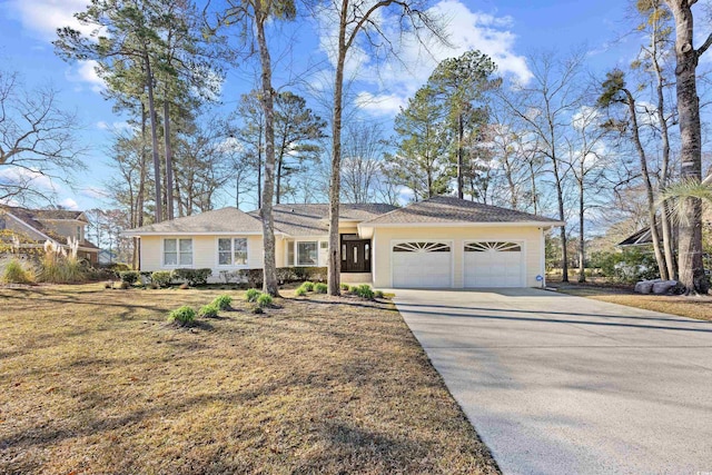 view of front of property with concrete driveway and an attached garage