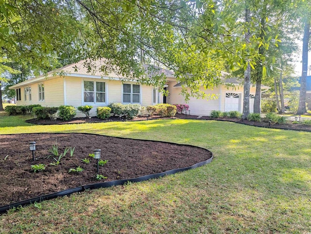 ranch-style home featuring a front yard