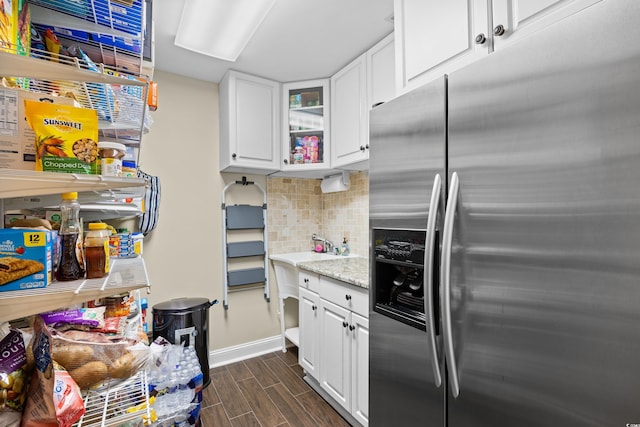 kitchen featuring stainless steel refrigerator with ice dispenser, dark wood-style flooring, backsplash, and white cabinetry