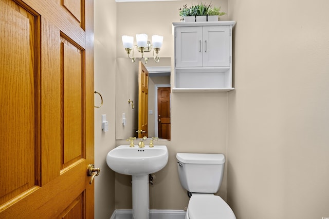 half bathroom with toilet and a sink