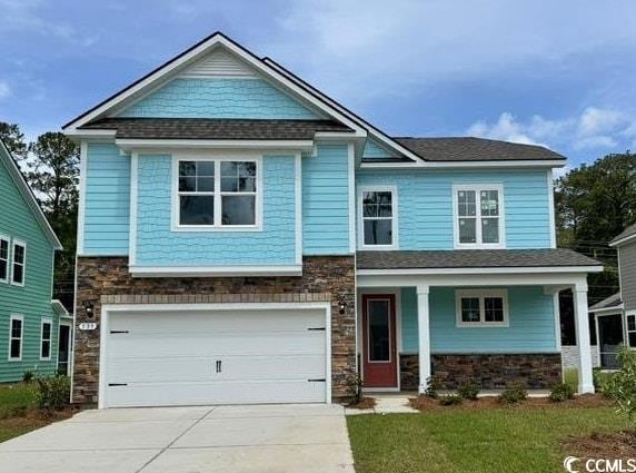 craftsman-style home with stone siding, driveway, a garage, and covered porch
