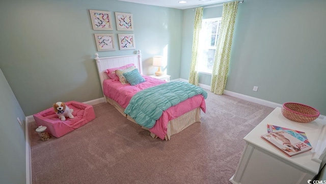 carpeted bedroom with baseboards