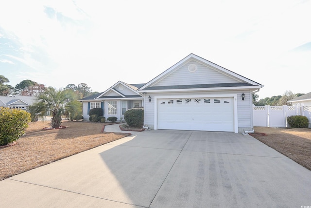 single story home featuring a garage, concrete driveway, and fence