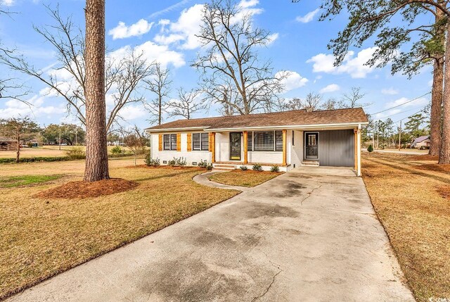 single story home featuring a front lawn, driveway, entry steps, crawl space, and brick siding