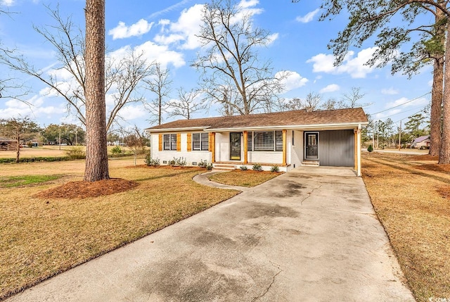 single story home with an attached carport, concrete driveway, and a front yard