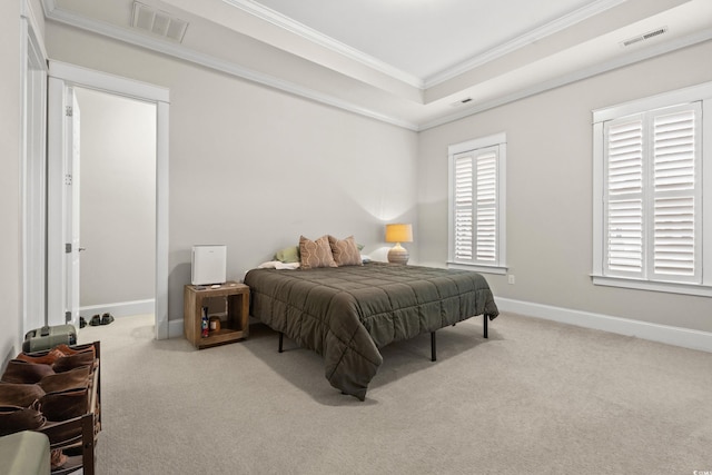 bedroom featuring visible vents, crown molding, baseboards, carpet, and a tray ceiling