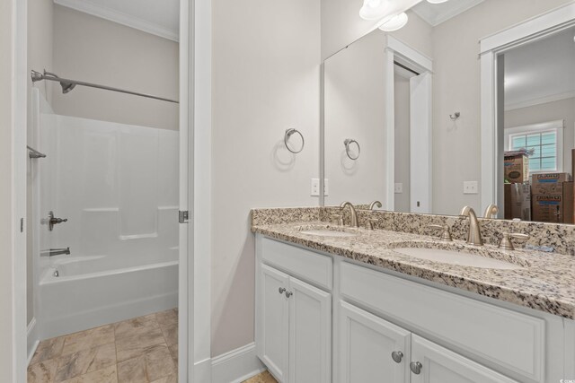 bathroom with double vanity, ornamental molding,  shower combination, and a sink