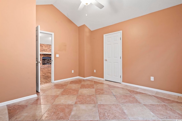 empty room featuring baseboards, lofted ceiling, and a ceiling fan