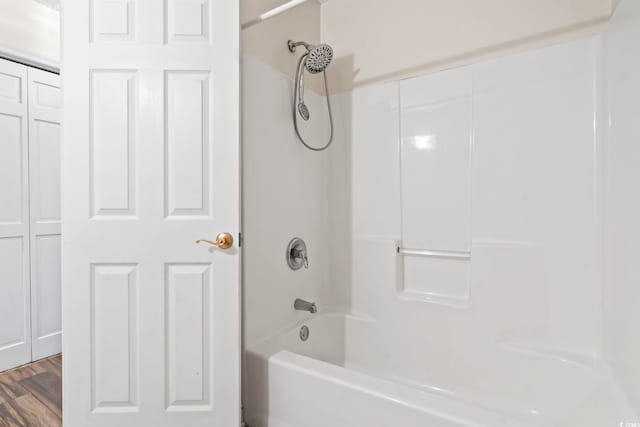 bathroom featuring wood finished floors and shower / washtub combination