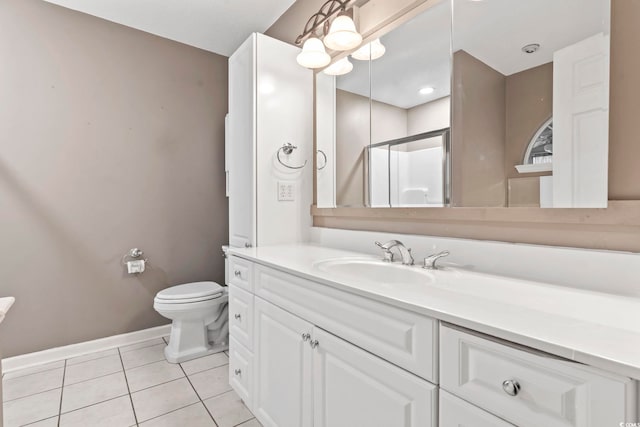 full bathroom featuring tile patterned flooring, baseboards, toilet, a stall shower, and vanity