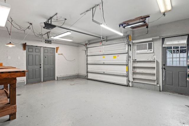 garage with a garage door opener and a wall mounted air conditioner