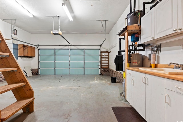 garage with a sink and a garage door opener