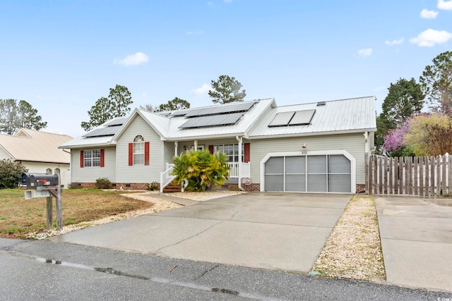 view of front of house with fence, concrete driveway, metal roof, crawl space, and an attached garage