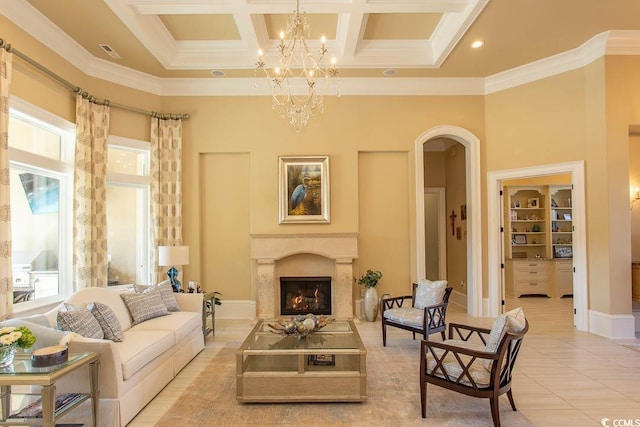 living area with a notable chandelier, coffered ceiling, arched walkways, a premium fireplace, and a towering ceiling