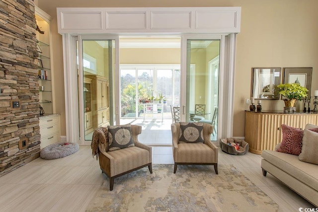 sitting room with built in features and light tile patterned floors