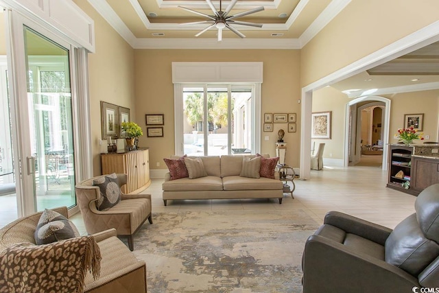 living area featuring a healthy amount of sunlight and crown molding