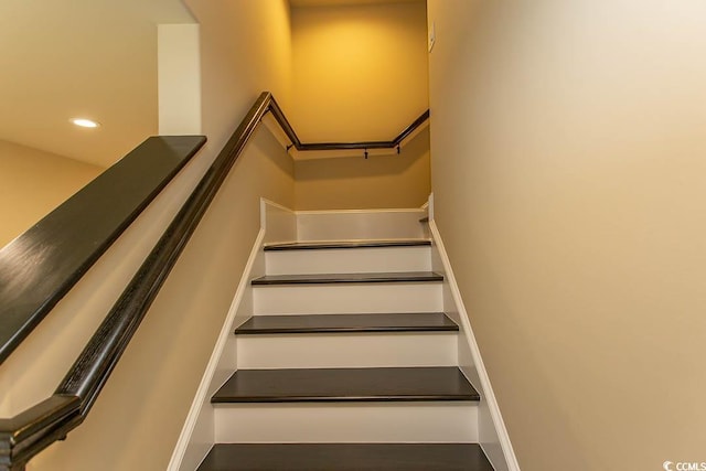 stairs with recessed lighting and baseboards