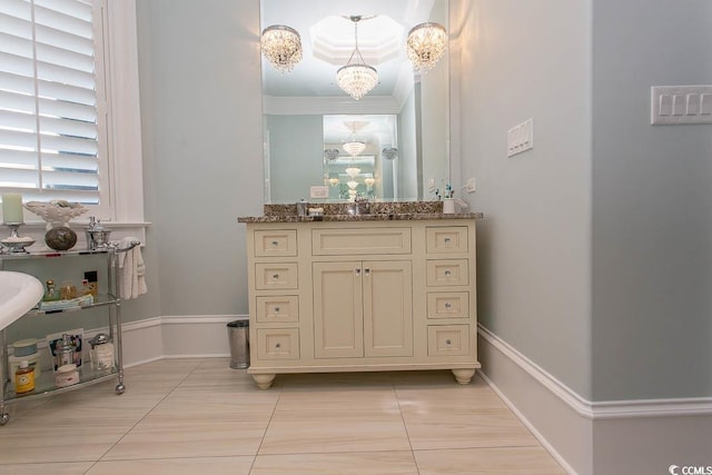 bathroom featuring ornamental molding, tile patterned flooring, baseboards, a chandelier, and vanity