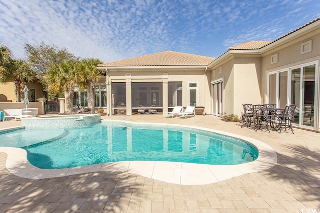 view of swimming pool with a pool with connected hot tub and a patio area