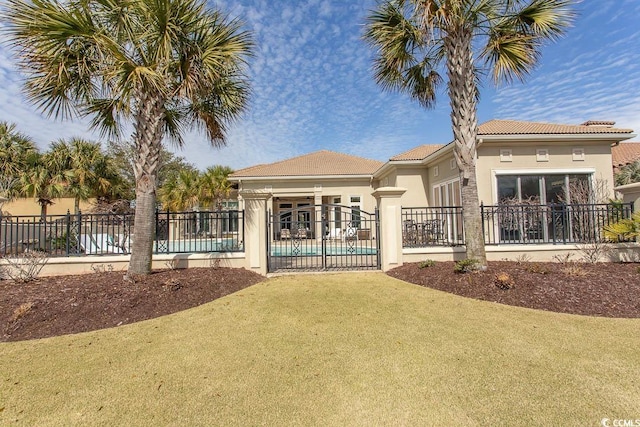 exterior space with stucco siding, a tile roof, a patio, fence, and a fenced in pool