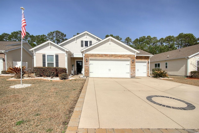 view of front of house with brick siding, driveway, a front lawn, and an attached garage