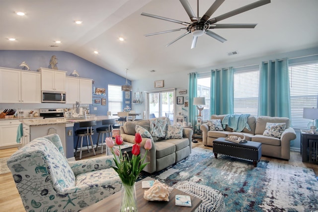 living area featuring visible vents, a ceiling fan, recessed lighting, light wood-style floors, and vaulted ceiling