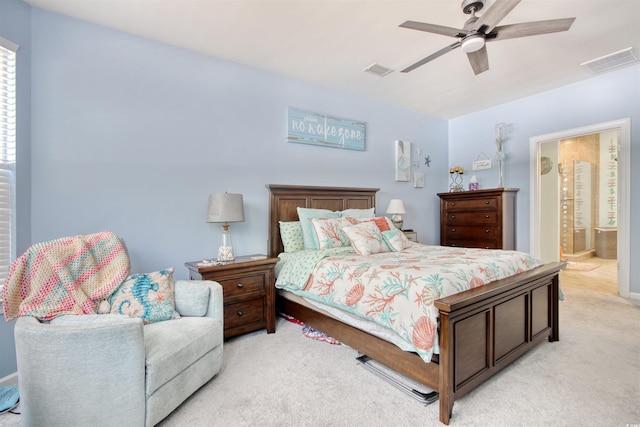 bedroom featuring ceiling fan, connected bathroom, visible vents, and light carpet