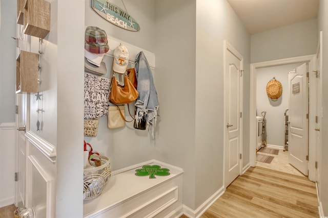 mudroom with baseboards and wood finished floors