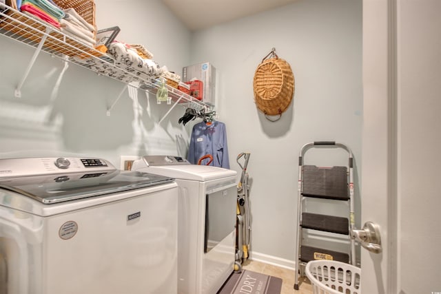 laundry room featuring light tile patterned flooring, laundry area, and separate washer and dryer