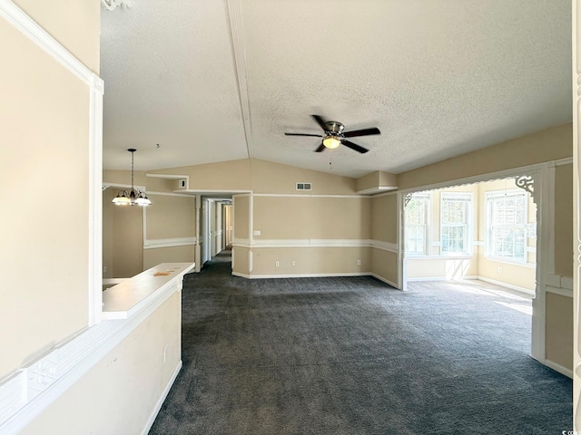 unfurnished room featuring visible vents, lofted ceiling, a textured ceiling, ceiling fan with notable chandelier, and dark colored carpet