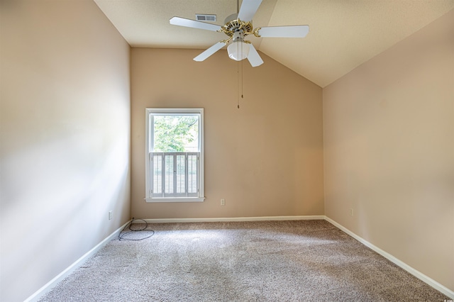 carpeted empty room featuring a ceiling fan, lofted ceiling, baseboards, and visible vents