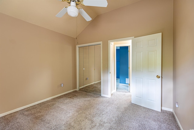 unfurnished bedroom featuring ceiling fan, baseboards, carpet, vaulted ceiling, and a closet