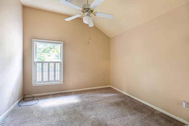 unfurnished room featuring vaulted ceiling, a ceiling fan, baseboards, and carpet floors