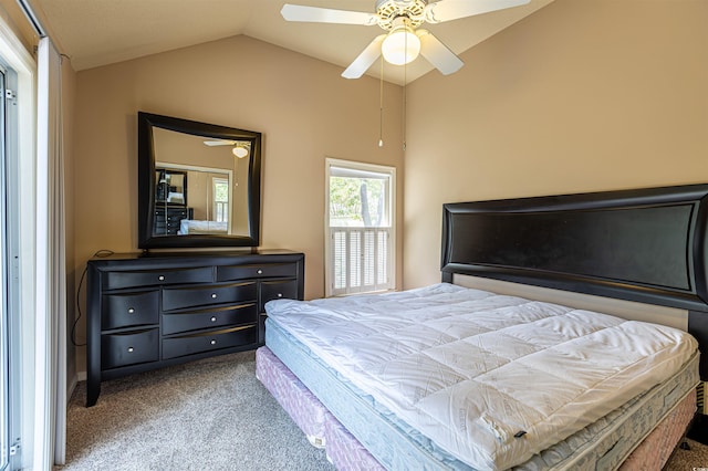 carpeted bedroom featuring lofted ceiling and a ceiling fan