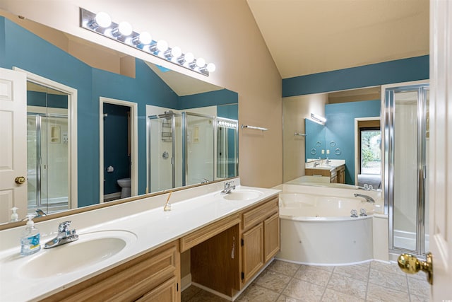 bathroom with a sink, a shower stall, double vanity, lofted ceiling, and a bath